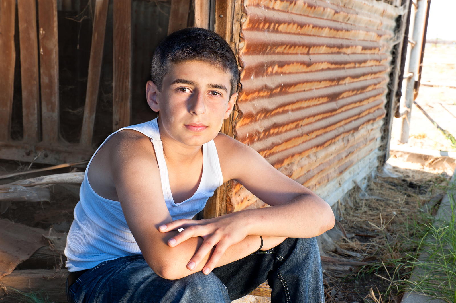 bigstock Boy Sitting In Old Barn 22182569