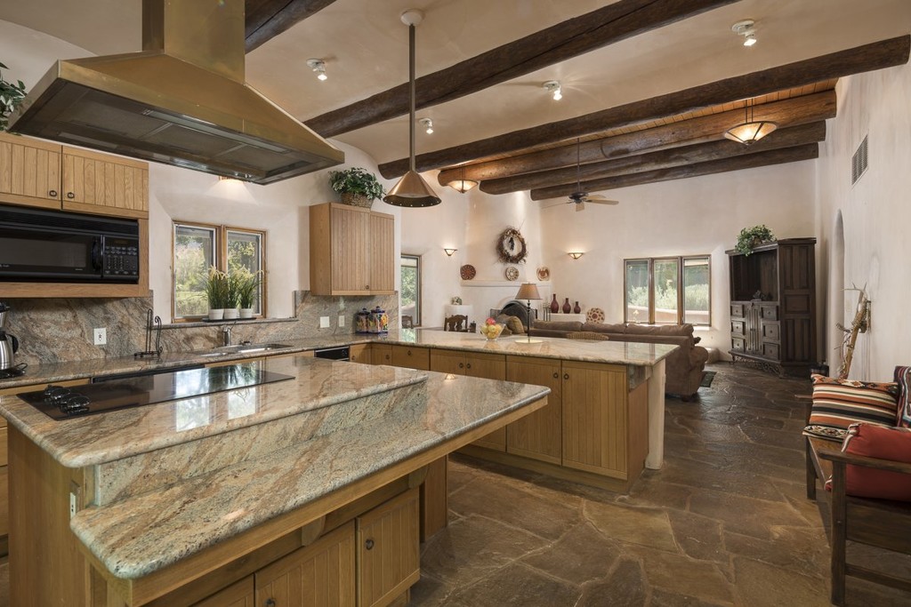 a chefs kitchen has ample space for a large center island it connects to a living room | Lamianow.gr